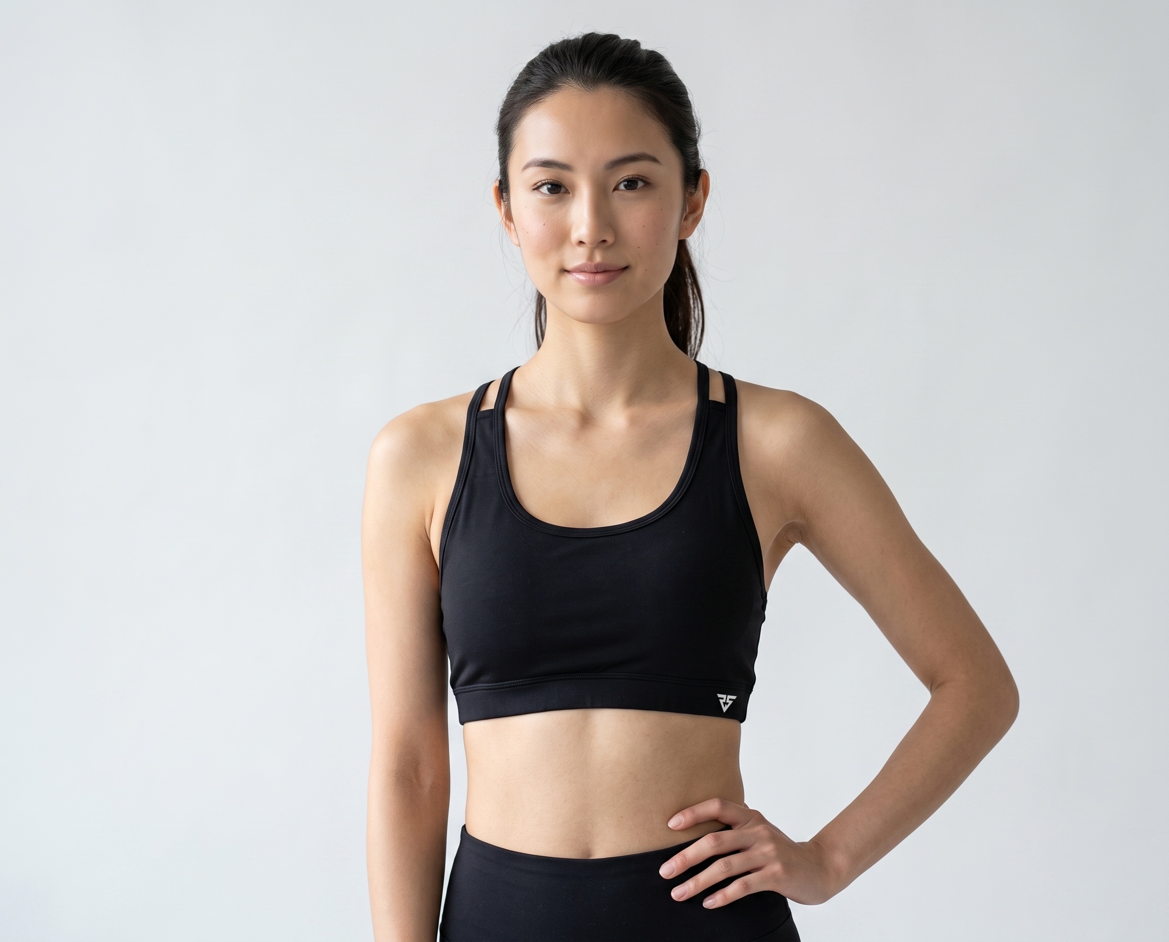 Black women’s performance sports bra with supportive underbust band and minimalist athletic front.
