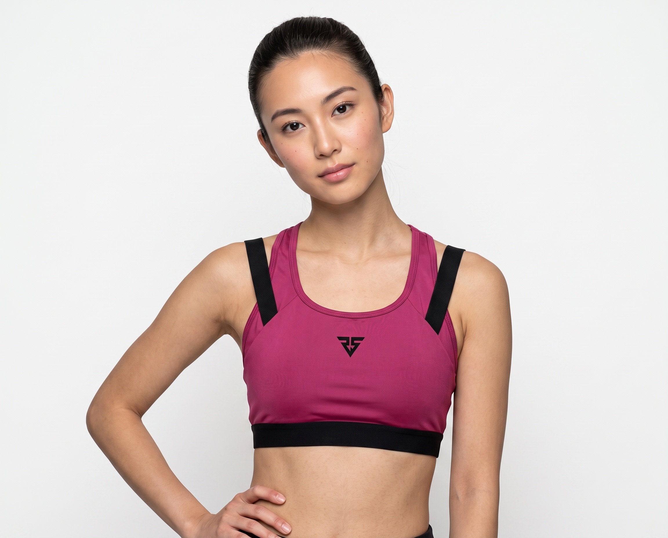 Magenta women’s racerback sports bra with wide black shoulder straps and contrast elastic underbust band.