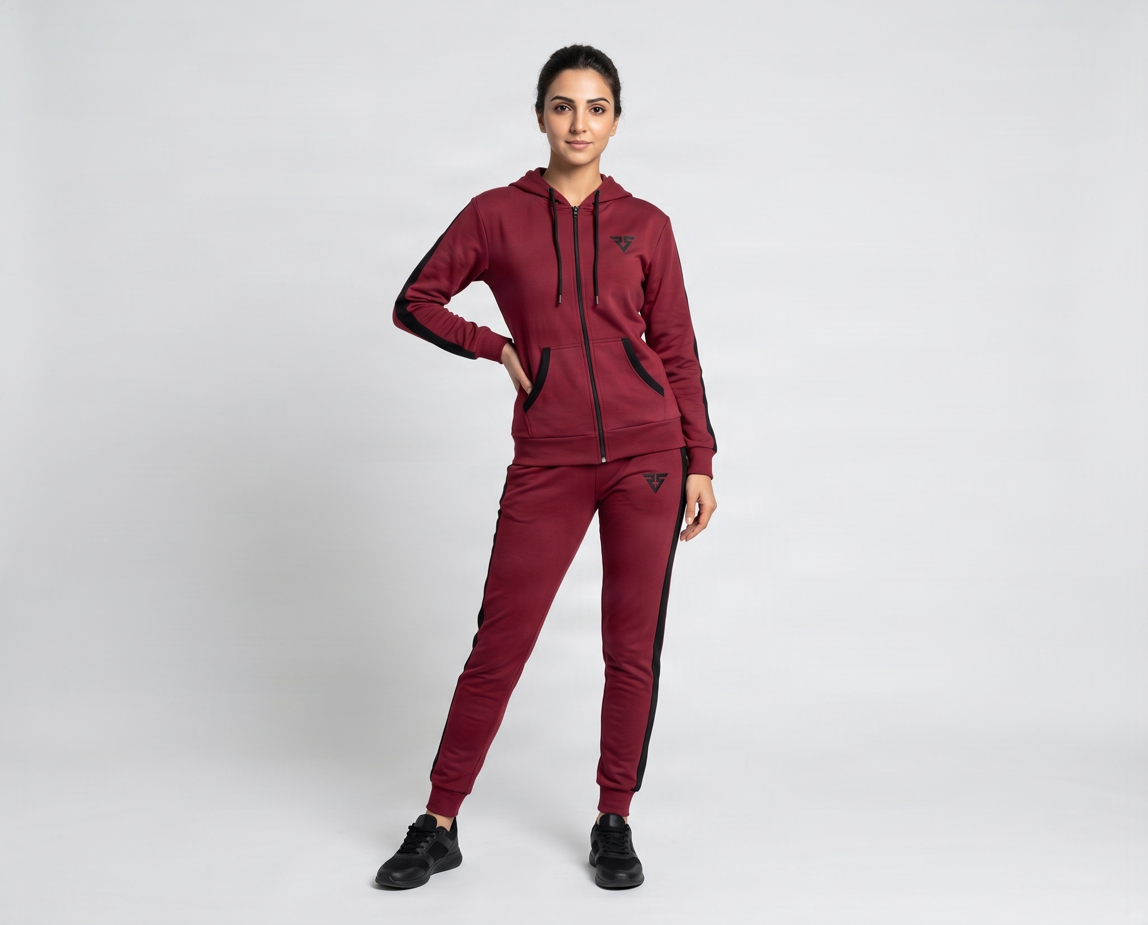 Front view of women’s maroon full-zip hooded tracksuit with contrast black panels and tapered joggers