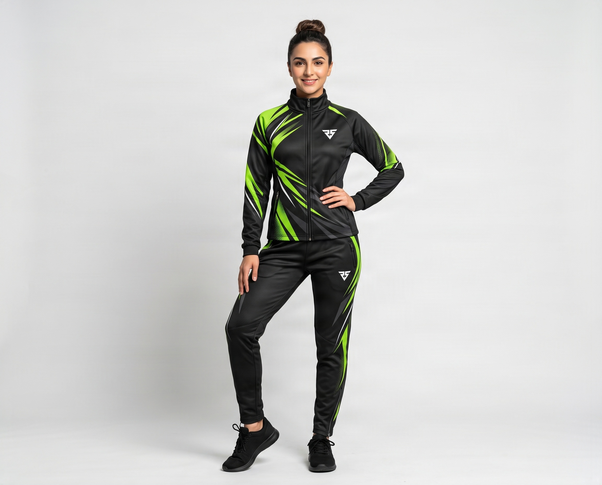 Front view of custom women’s sublimated team tracksuit with black and fluorescent green graphic design