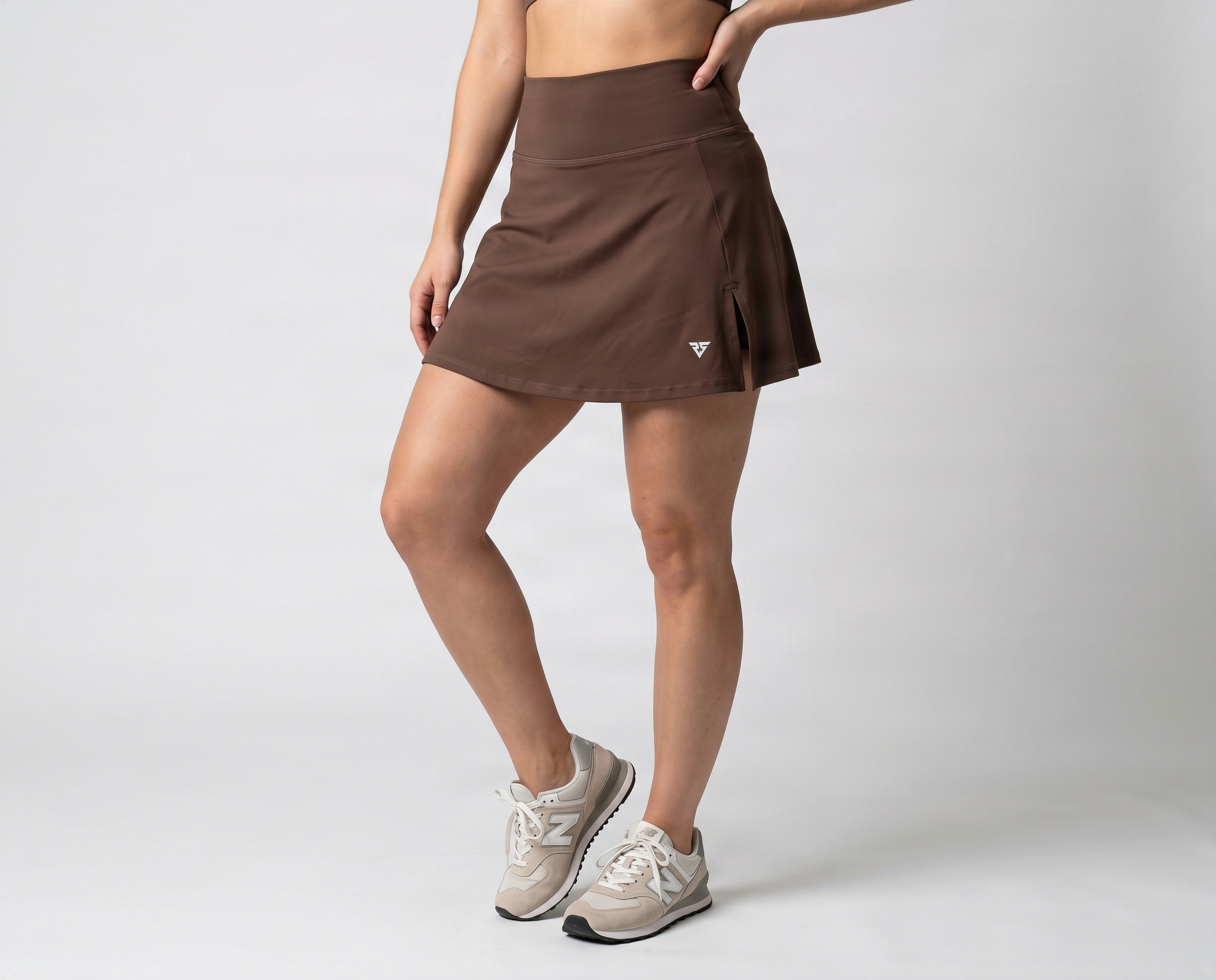 Brown women’s performance skirt with high-rise waistband and side slit by Remington Sports