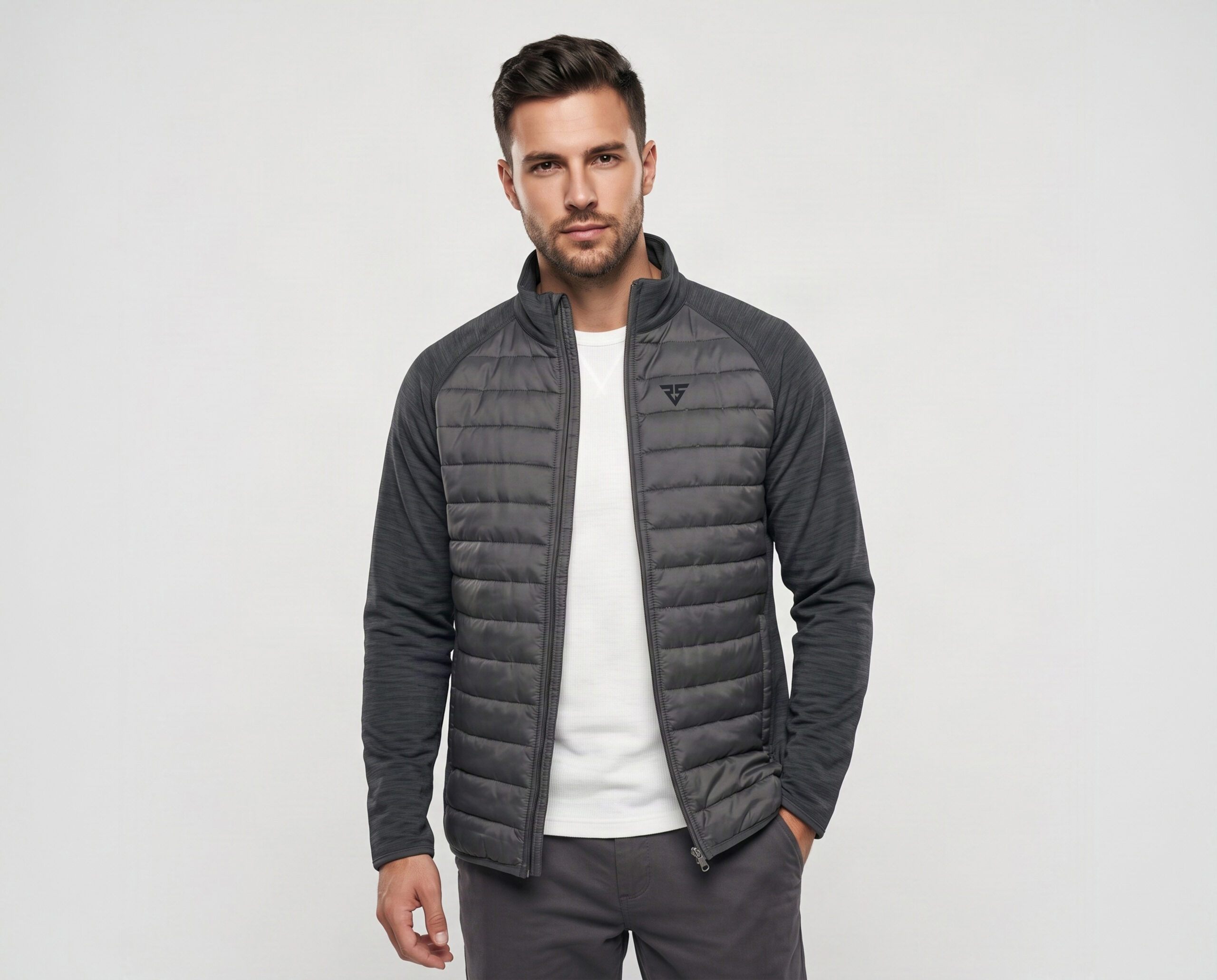 Men’s grey hybrid padded jacket with quilted front panels and stretch-knit sleeves, worn open
