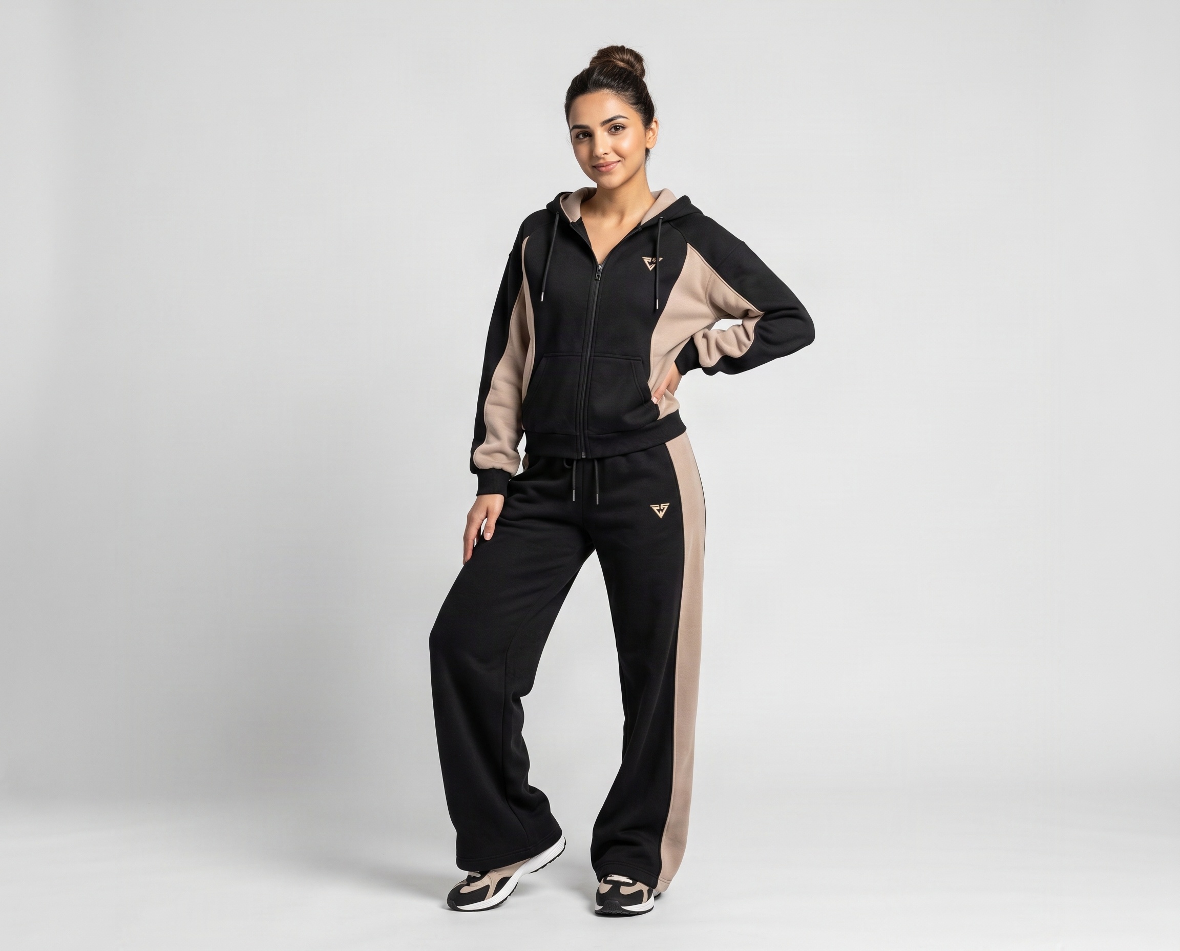 Front view of women's black fleece tracksuit with beige contrast panels, full-zip hoodie and wide-leg pants