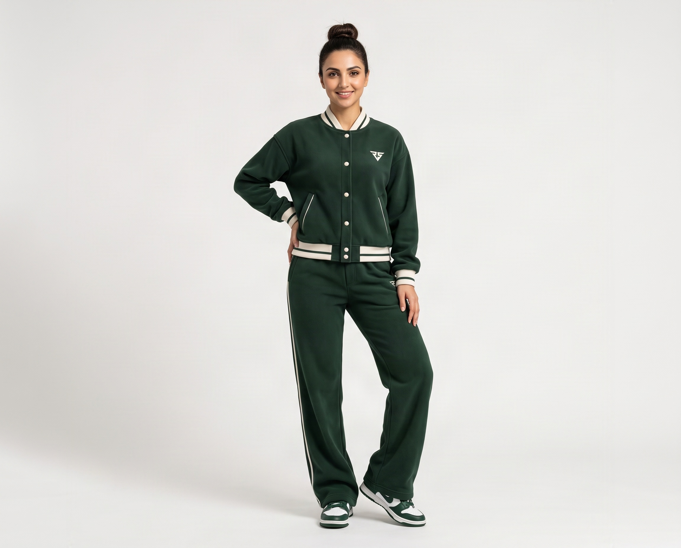 Front view of women's forest-green fleece tracksuit featuring snap-button varsity jacket and matching wide-leg pants