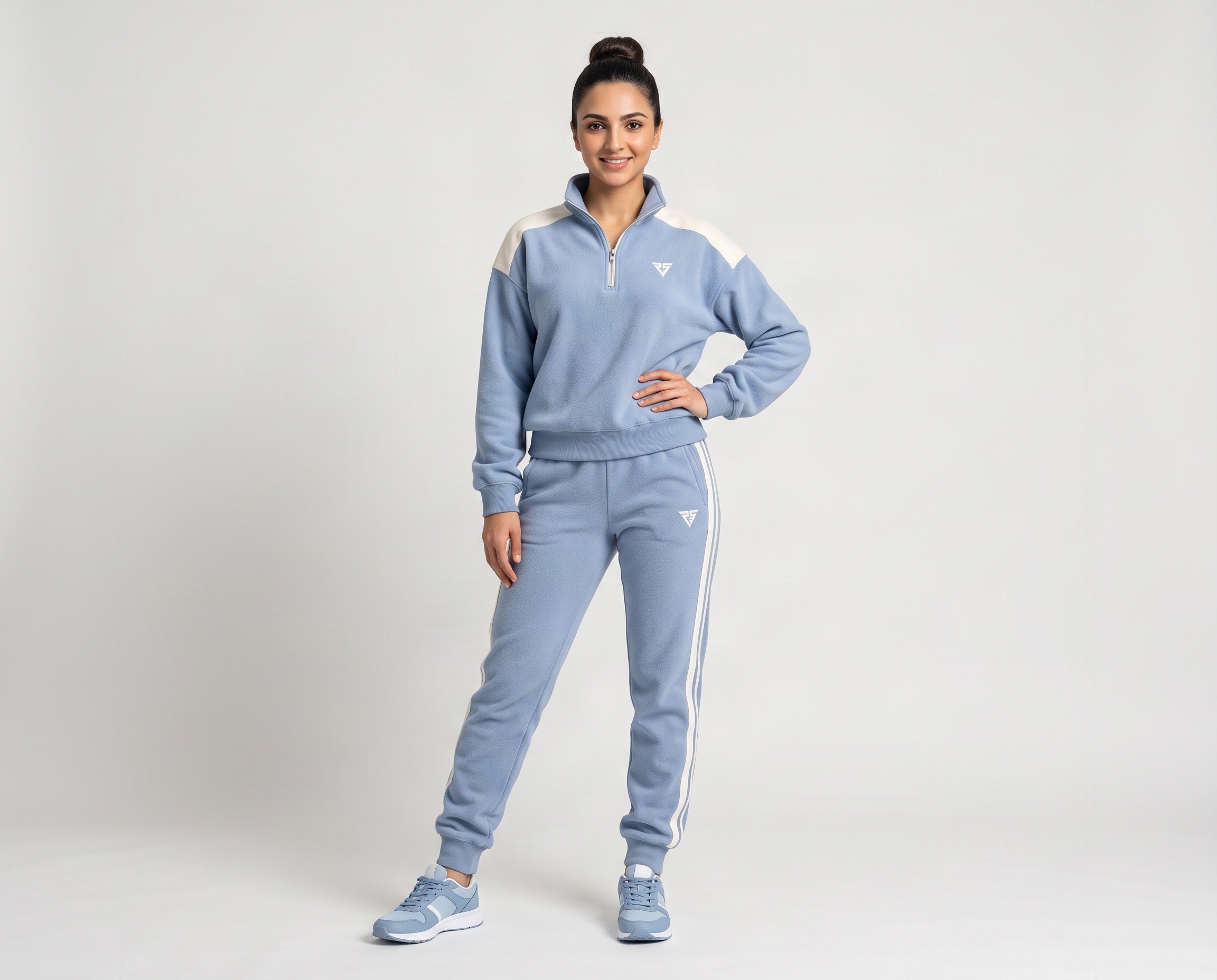 Front view of women's powder-blue quarter-zip fleece tracksuit with white shoulder panels and matching joggers