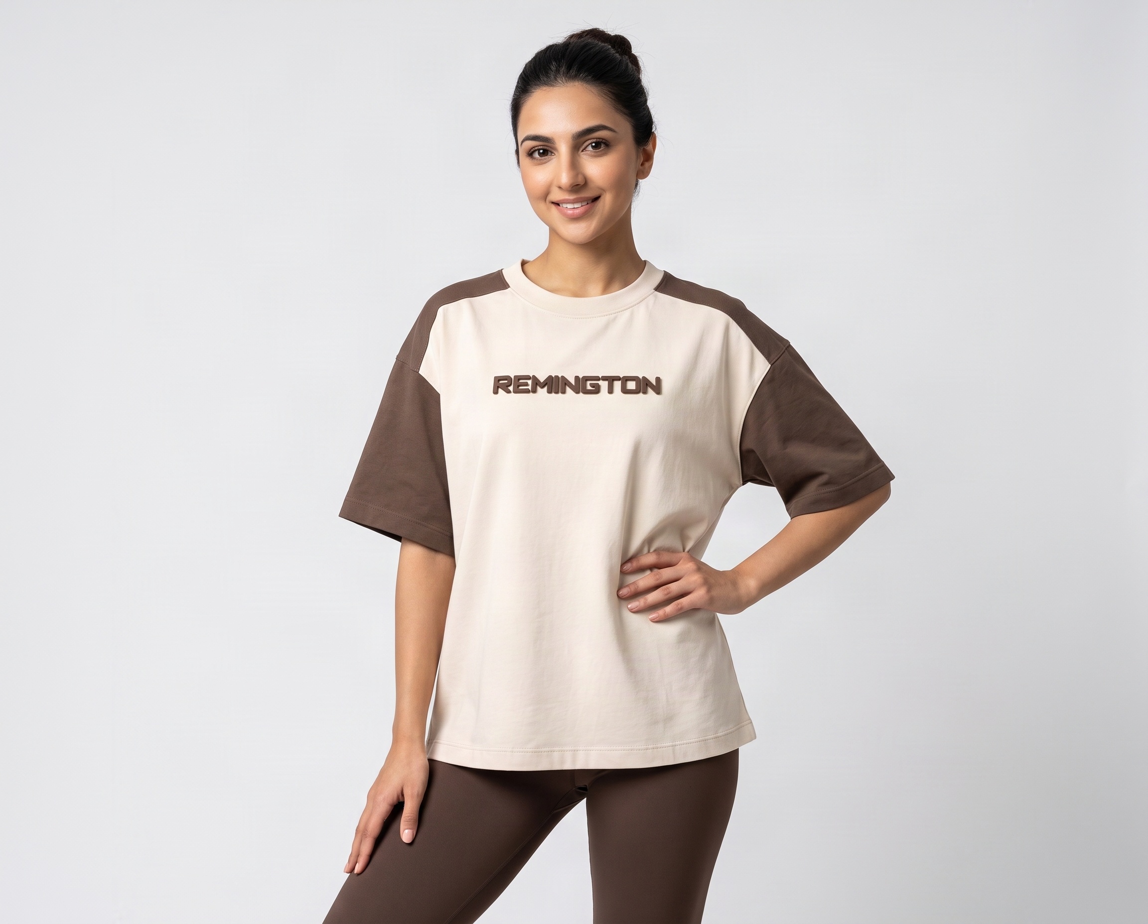 Front view of women's two-tone oversized T-shirt featuring a cream body, brown sleeves and REMINGTON chest logo