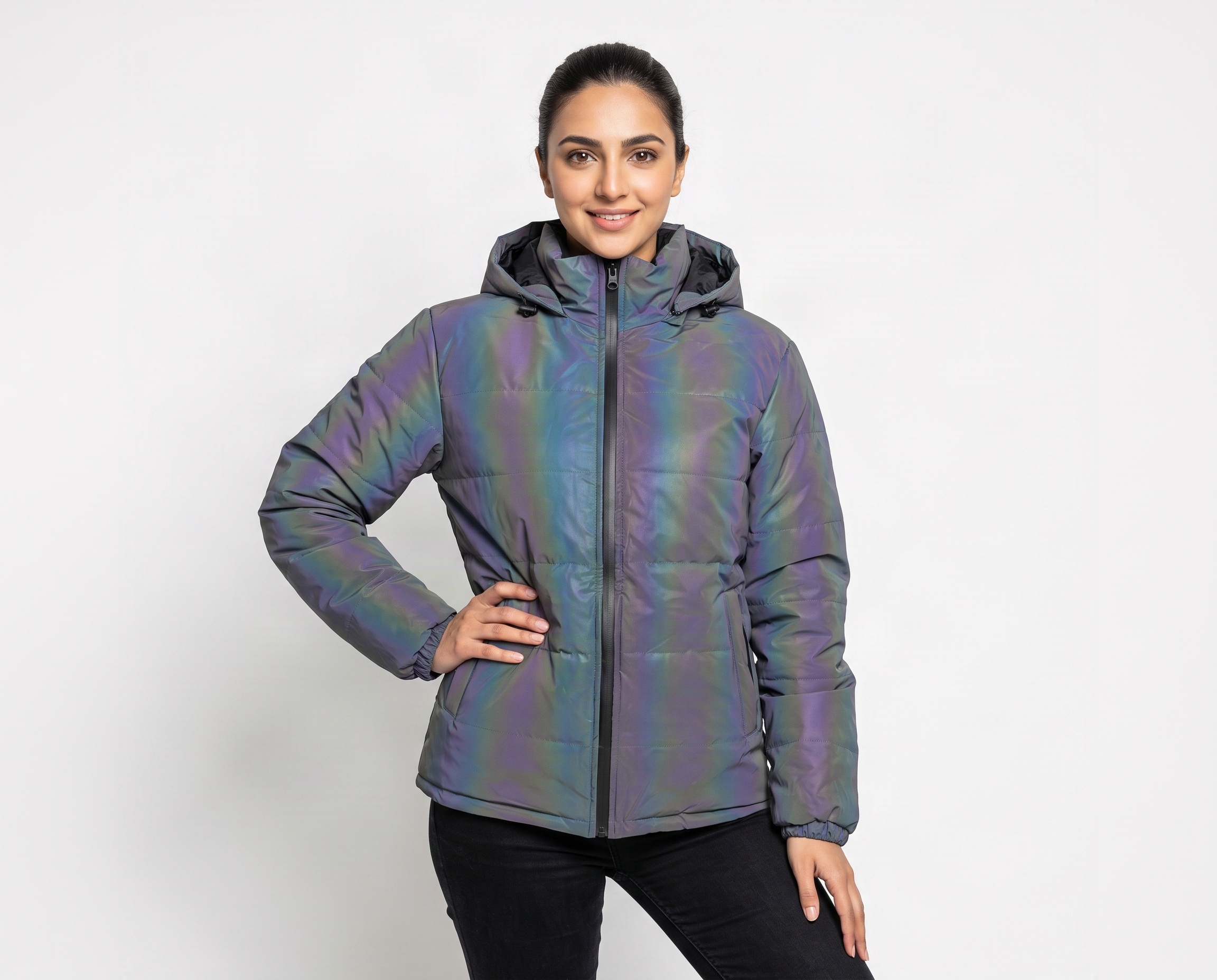 Woman wearing a multicolor iridescent puffer jacket with full-length front zipper, padded hood and side pockets