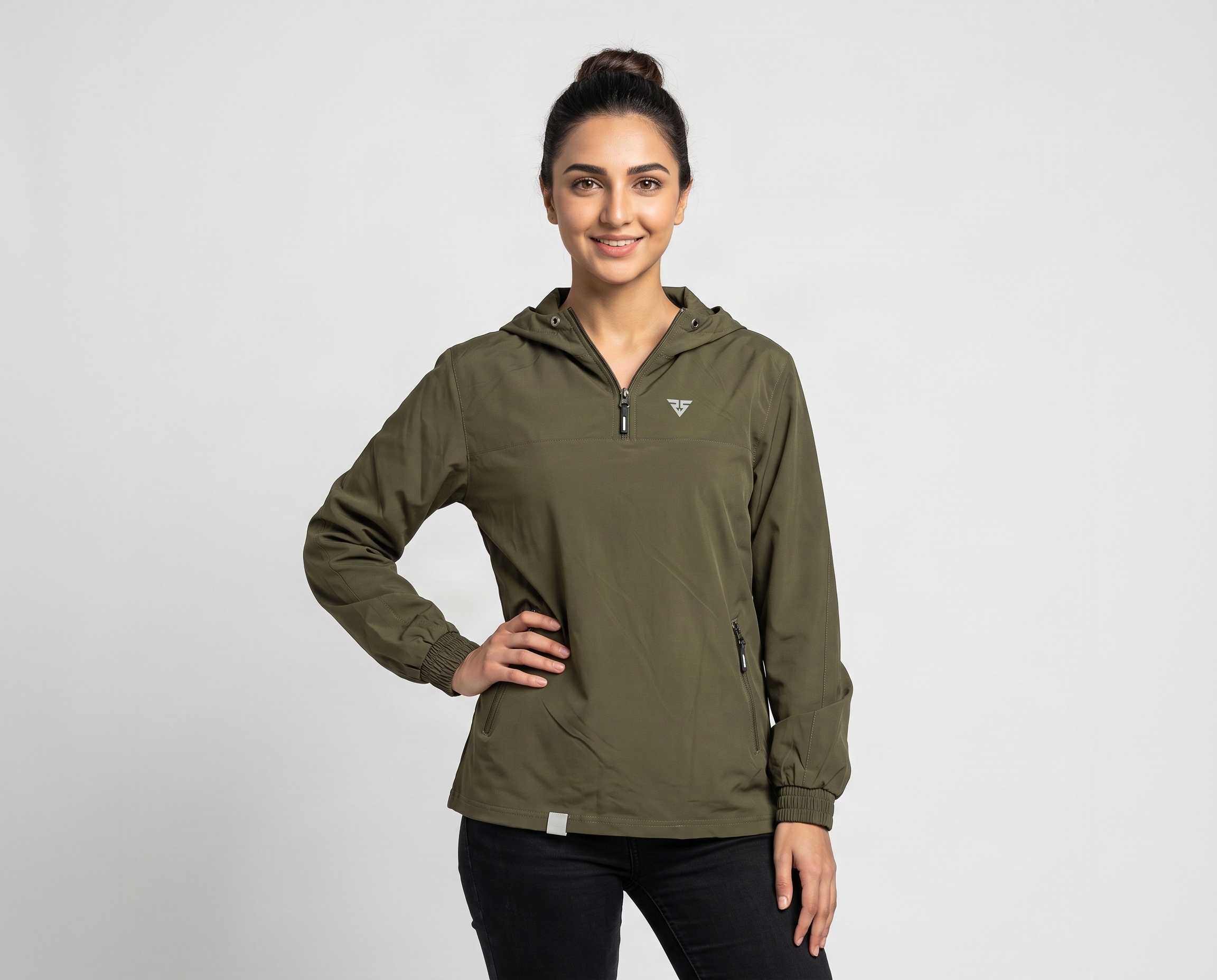 Woman wearing an olive-green hooded half-zip pullover jacket with side zipper pockets and elasticated cuffs